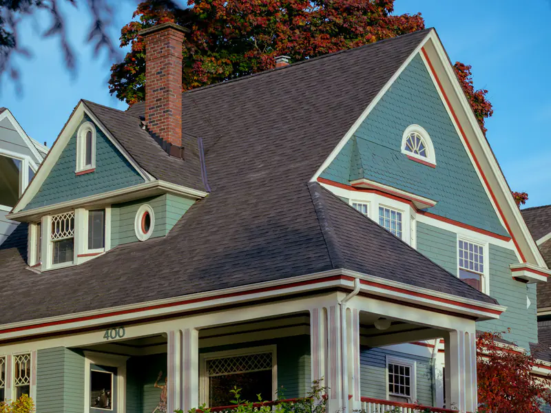 Two-story craftsman house with sage-green siding and cream trim