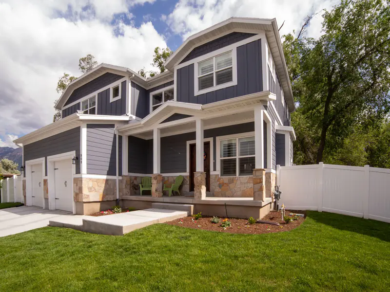 Two-story house with blue-gray siding, white trim and a two-car garage